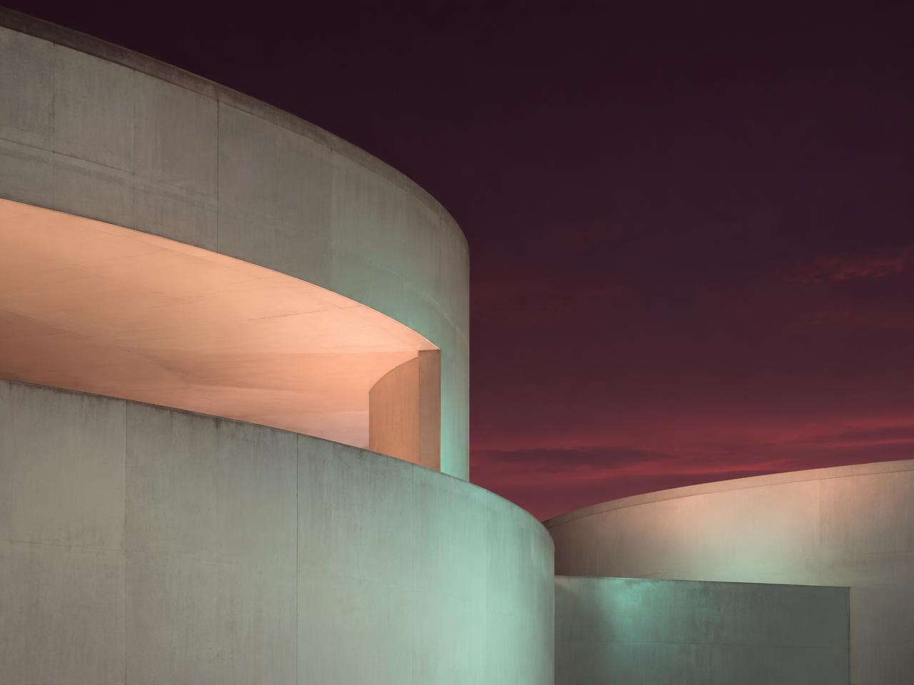 AI-generated curved concrete architecture at dusk